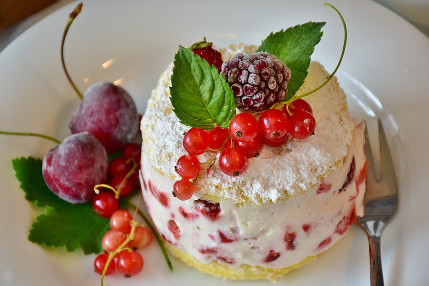 Homemade Cream Cake With Fresh Berries And Mint On White Plate