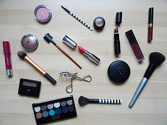 Flat Lay Collection Of Beauty Products And Brushes On Wood