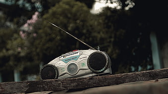 Vintage Golden Stone Cassette Radio on Wooden Log