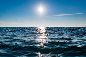 Sunlight Reflection on Deep Blue Ocean Horizon