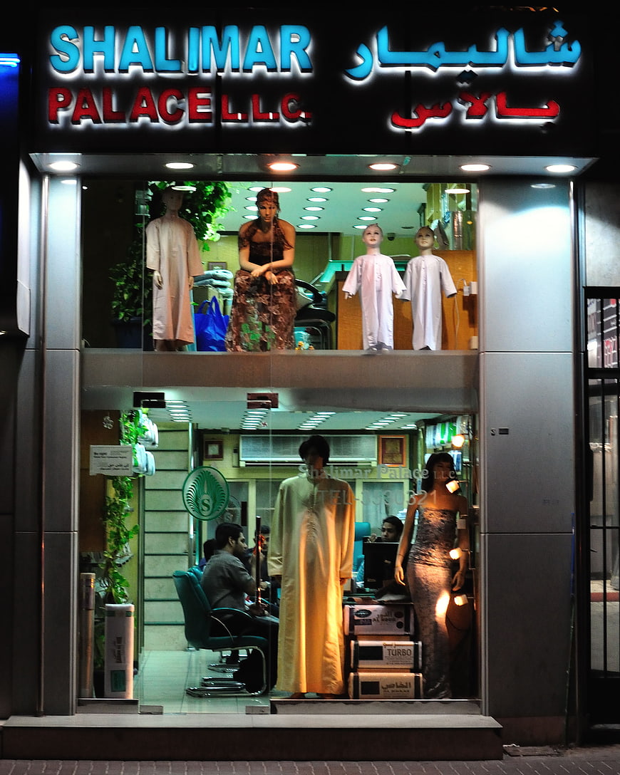 Shalimar Palace clothing store window display at night