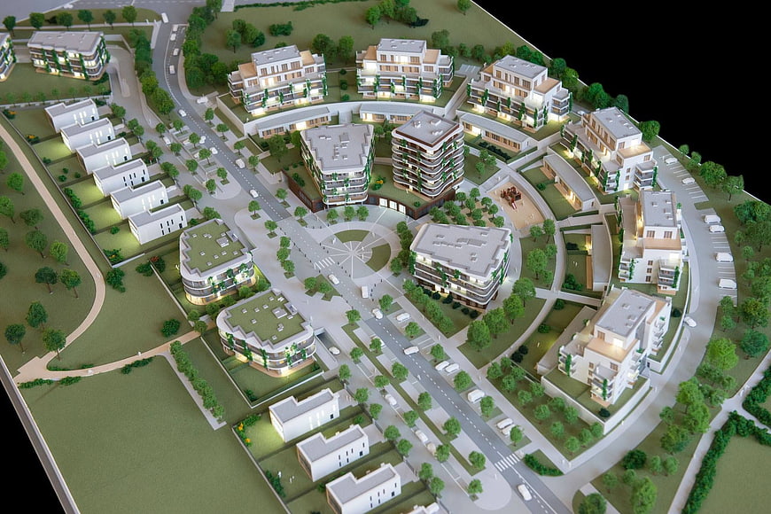 Architectural model of modern residential complex with green spaces