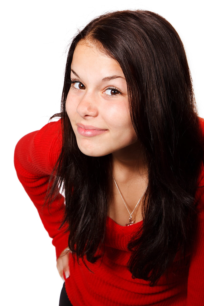 Young Woman in Red Sweater Leaning Forward on White Background