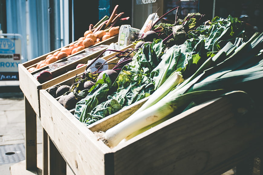 Fresh organic vegetables in wooden crates at outdoor market