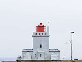 White Lighthouse with Red Roof on Overcast Day