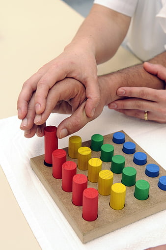 Occupational Therapist Assisting Patient With Hand Dexterity Exercise
