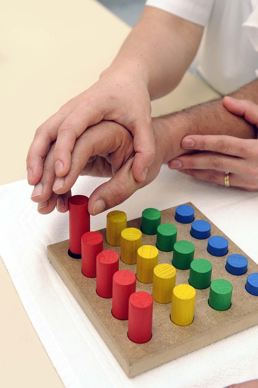 Occupational Therapist Assisting Patient With Hand Dexterity Exercise