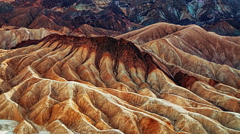 Colorful eroded badlands landscape with textured ridges