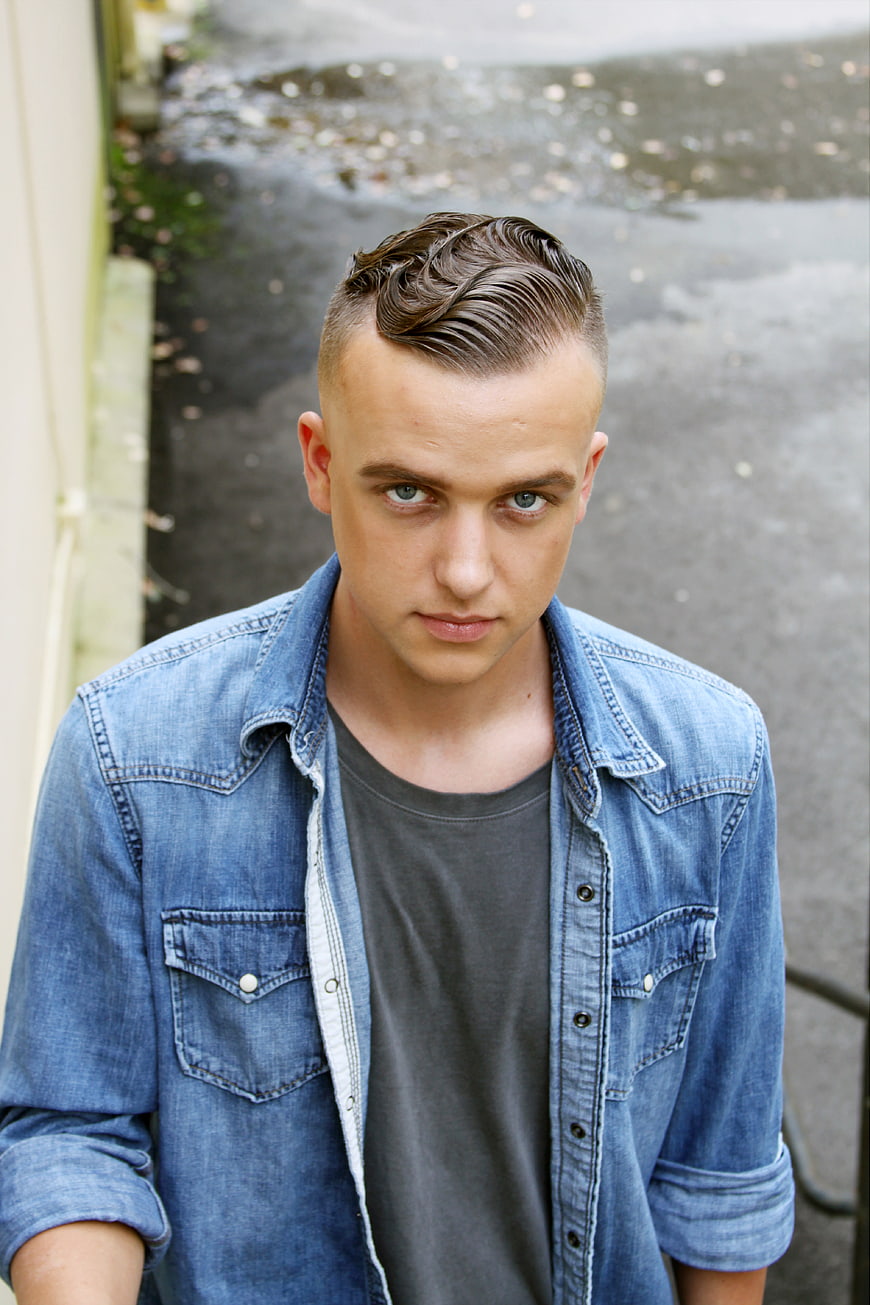 Young Man in Denim Shirt Looking Up from High Angle