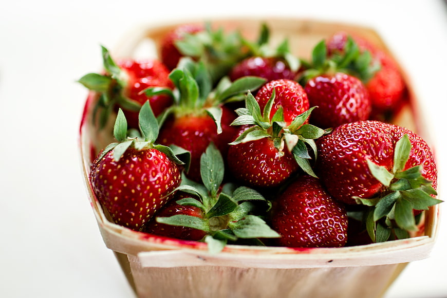 Fresh Red Strawberries in Wooden Basket on White Background