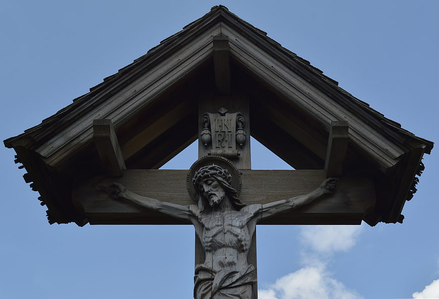 Wooden Crucifix Statue Under Roof Against Blue Sky