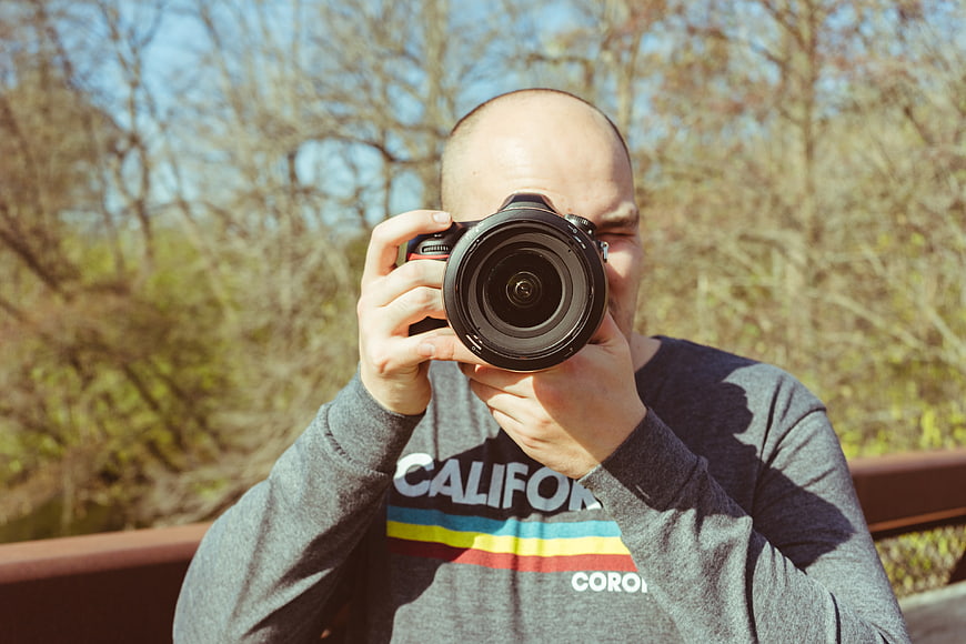 Man Taking Photo with DSLR Camera Outdoors