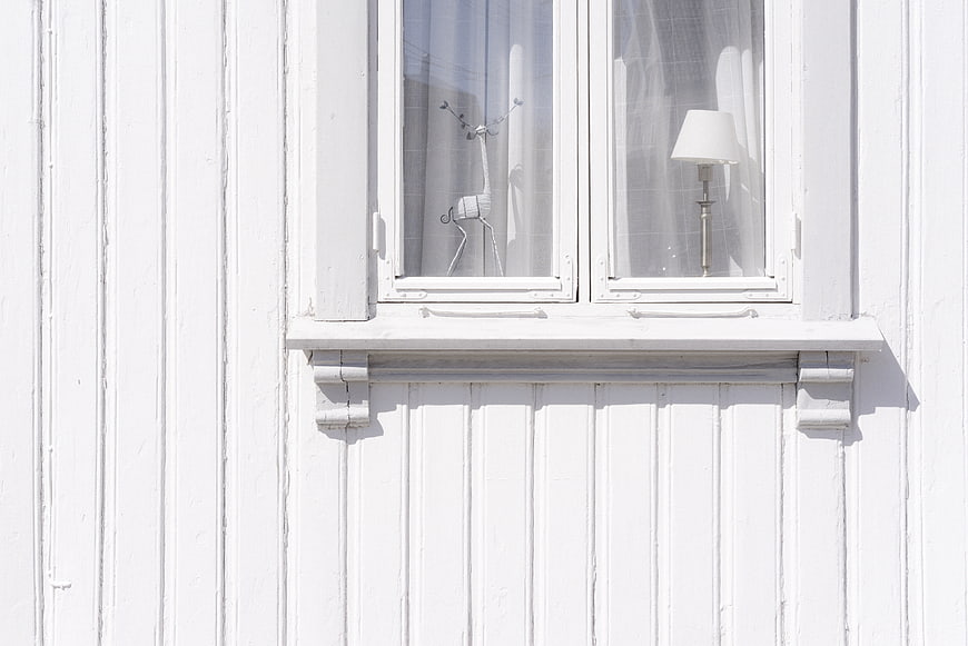 Minimalist White Wooden House Exterior with Window
