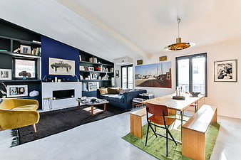 Modern Open-Plan Living Room With Dining Area And Blue Accent Wall