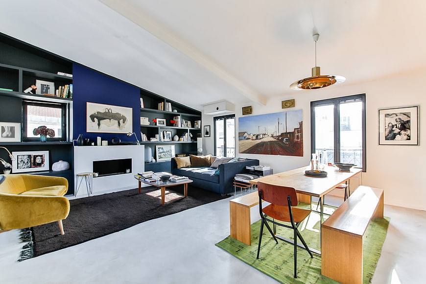 Modern Open-Plan Living Room With Dining Area And Blue Accent Wall