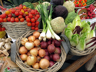 Fresh organic vegetables in wicker baskets at a farmers market