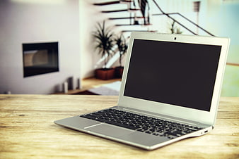 Silver Laptop on Wooden Table in Modern Home Office