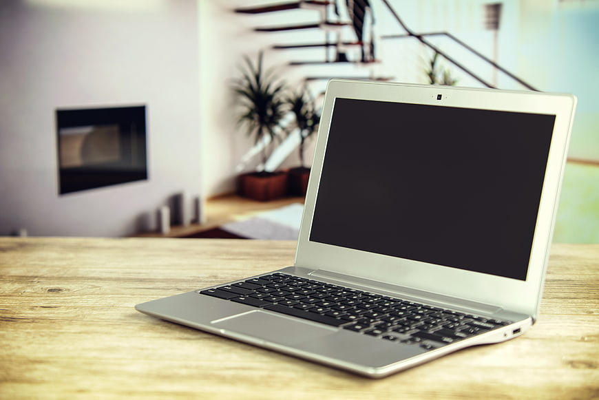 Silver Laptop on Wooden Table in Modern Home Office