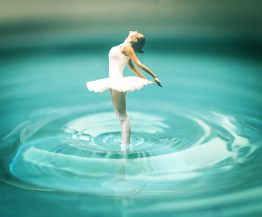 Ballerina standing in water with ripples
