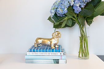Blue Hydrangeas and Gold Dog Sculpture on Books