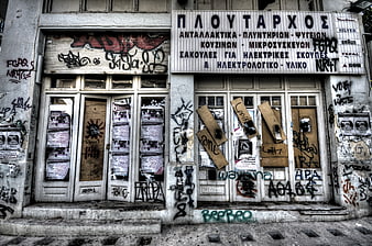 Abandoned Greek Shop Facade with Graffiti and Decay