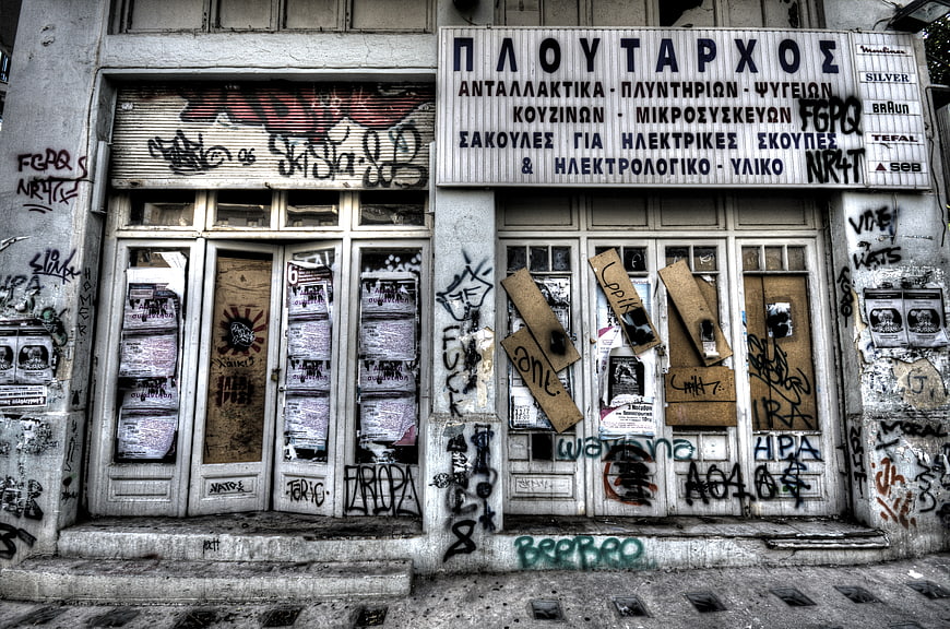 Abandoned Greek Shop Facade with Graffiti and Decay