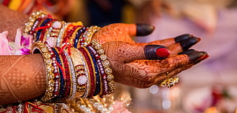 Indian Bride Hands with Mehndi and Colorful Bangles