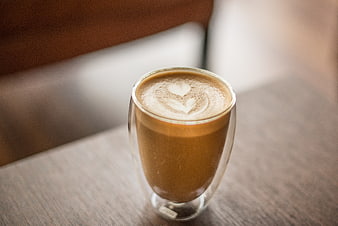 Latte with heart art in double-walled glass