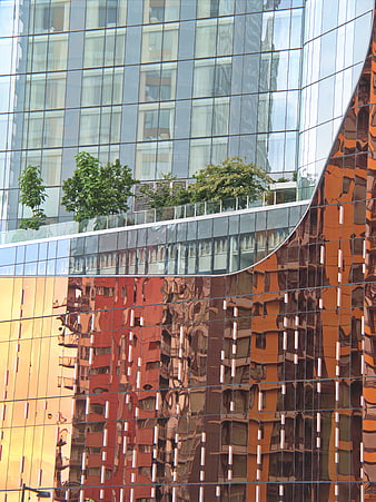 Modern Glass Building Facade with Reflective Orange Panels