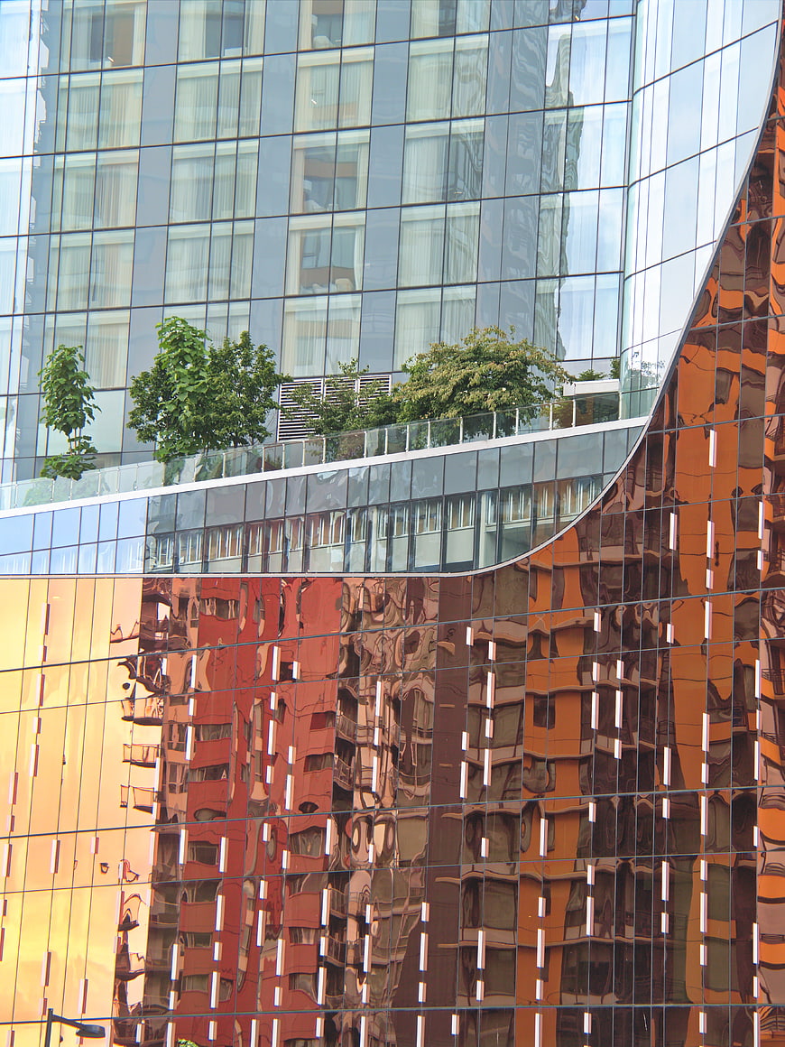 Modern Glass Building Facade with Reflective Orange Panels
