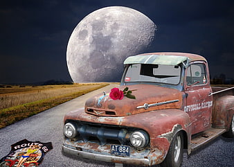 Rusted Vintage Ford Truck with Red Rose and Route 66 Sign Under Giant Moon