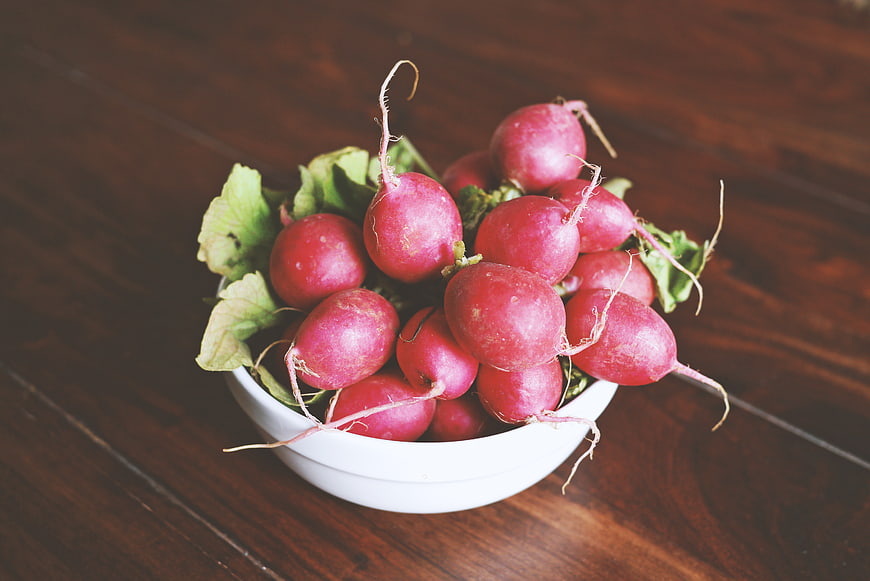 Fresh Red Radishes in White Bowl on Wooden Table