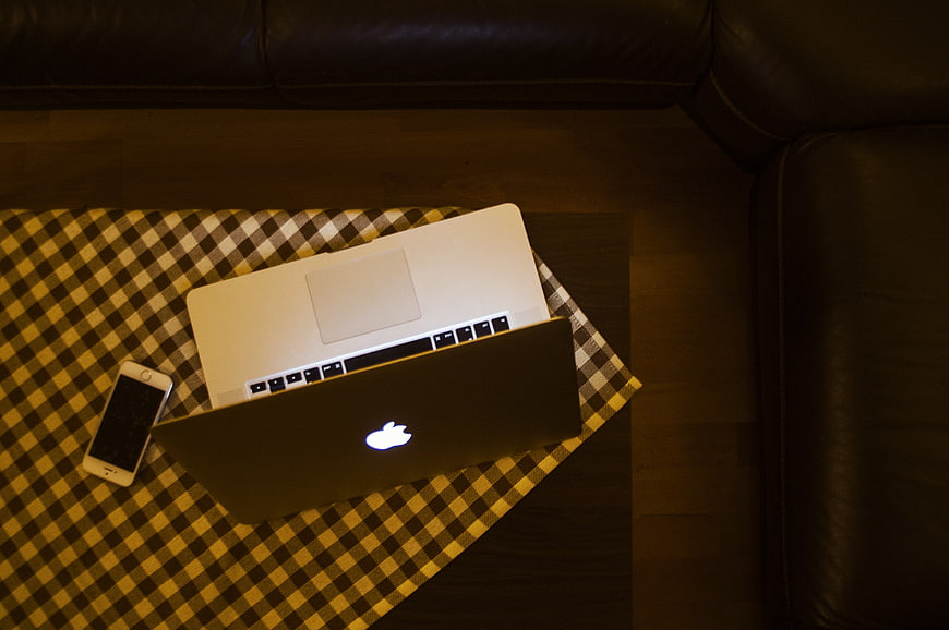 Top view of laptop and smartphone on checkered cloth