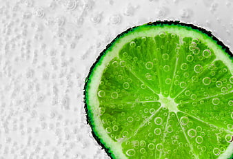 Fresh Lime Slice in Sparkling Water with Bubbles