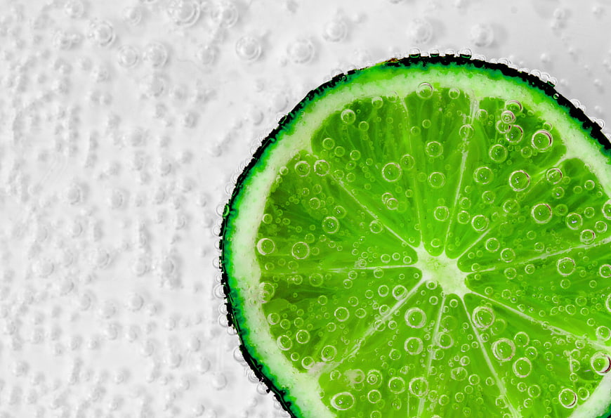 Fresh Lime Slice in Sparkling Water with Bubbles