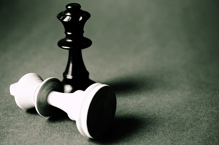 Black Chess King Standing Over Fallen White King