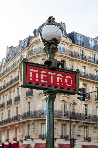 Paris Metro Sign with Classic Haussmannian Architecture Background