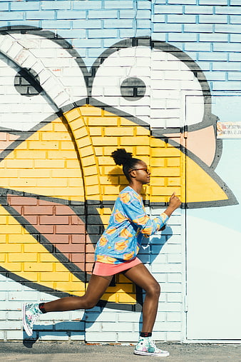 Woman Running Past Colorful Street Art Mural