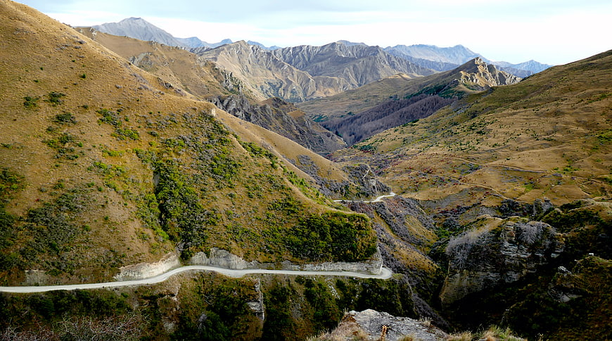 Winding Mountain Road Through Golden Valley Landscape
