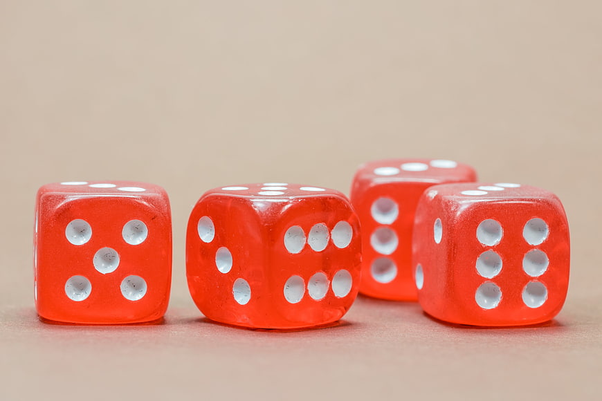 Four Red Dice On Beige Background
