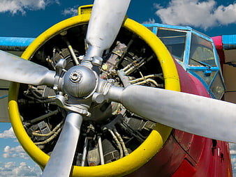 Close-up of vintage airplane propeller engine against blue sky