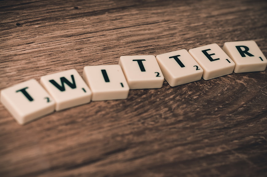 Twitter spelled with Scrabble tiles on wooden background