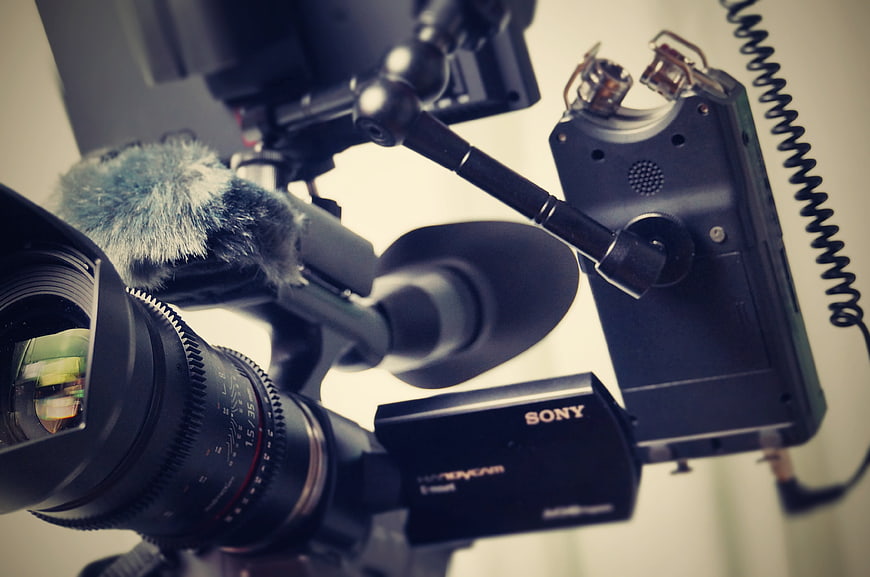 Close-up of professional video camera with microphone and lens
