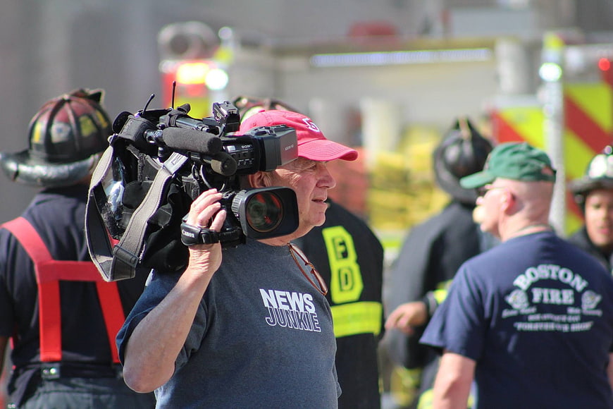 News Junkie Cameraman Filming Firefighters at Emergency Scene