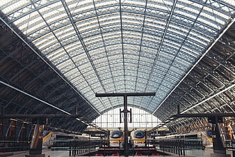 Grand Arched Roof of Historic Train Station with Trains