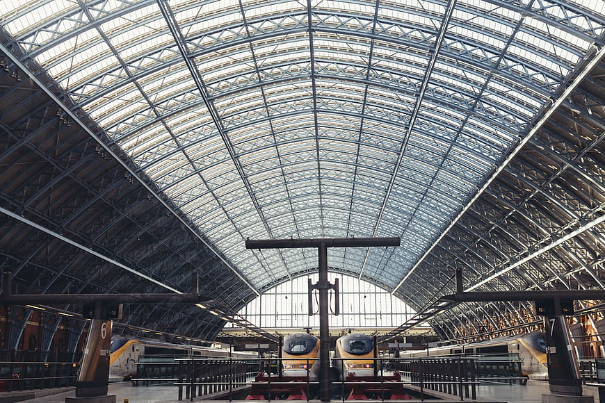 Grand Arched Roof of Historic Train Station with Trains