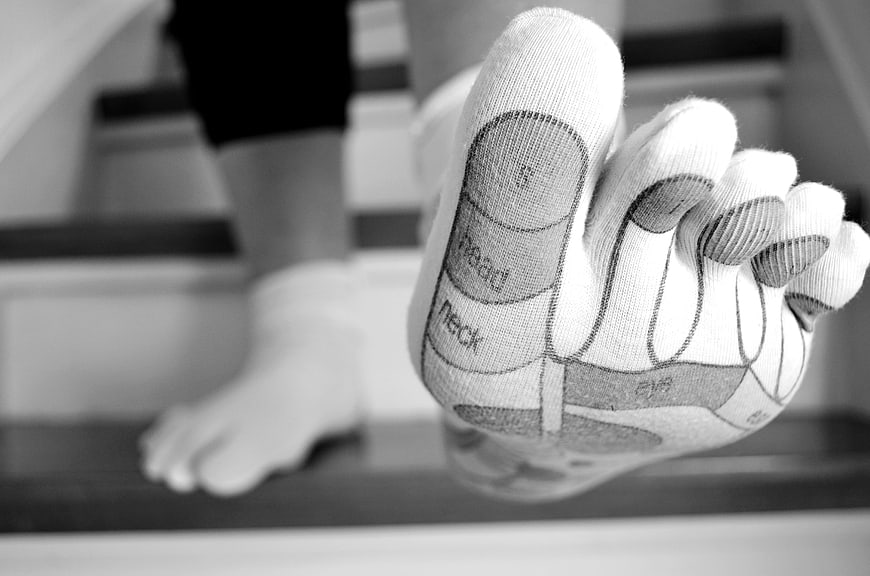 Close-up of foot reflexology map on toe socks