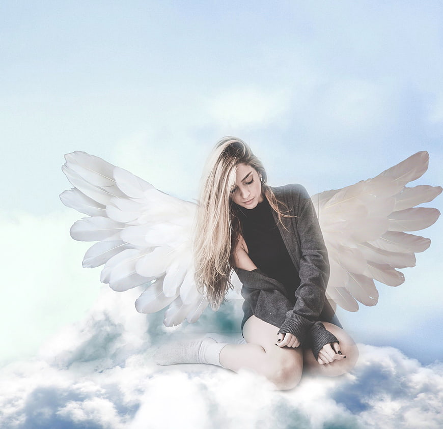 Sad angel woman sitting on clouds in blue sky