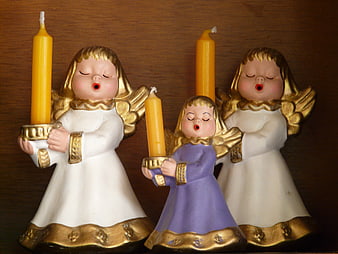 Three Singing Angel Figurines Holding Yellow Candles