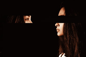 Conceptual Portrait of Woman With Split Face and Dark Background